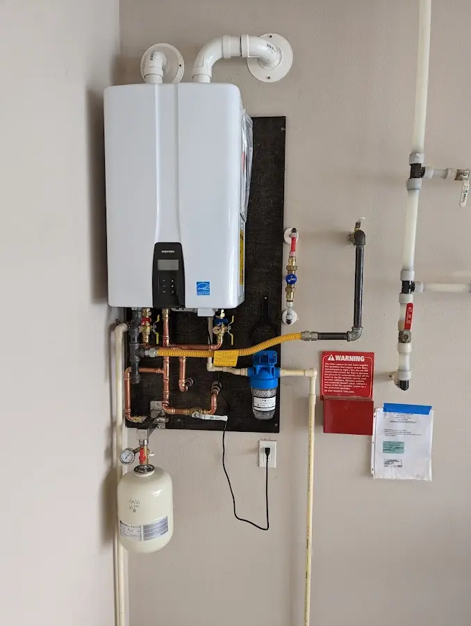 Professional plumber installing copper piping in a Maquoketa home